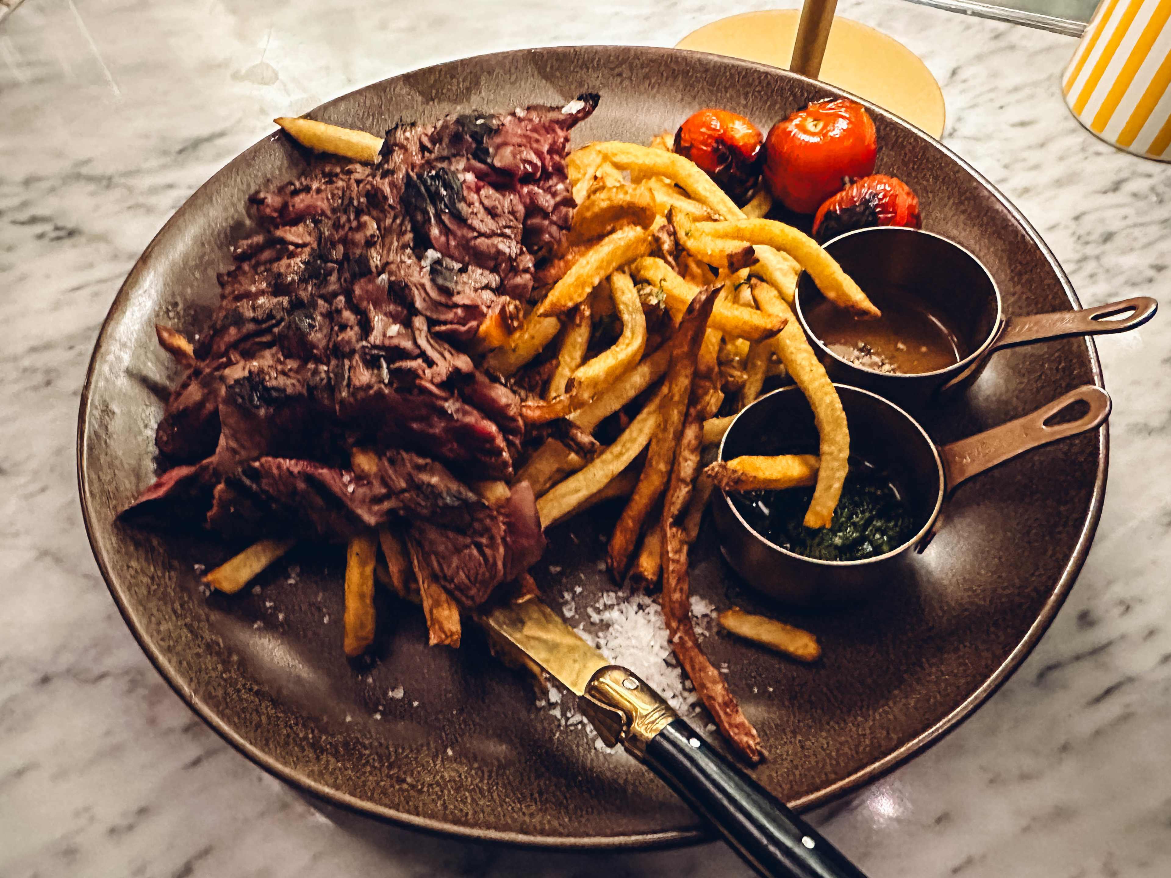 Steak and french fries on a plate.