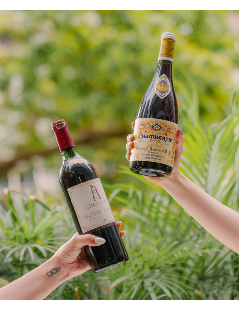 Two of the bottles of wine on the new programme being held aloft by members of the restaurant team