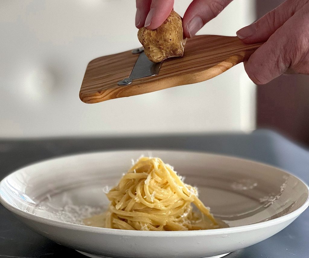 shaving truffles on pasta