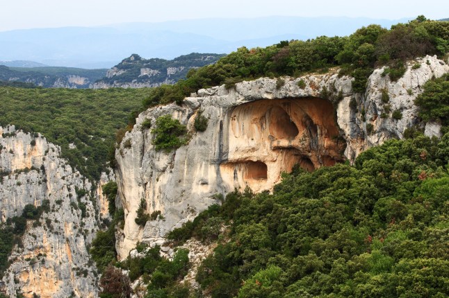 A mountainous landscape with trees and jagged rocks
