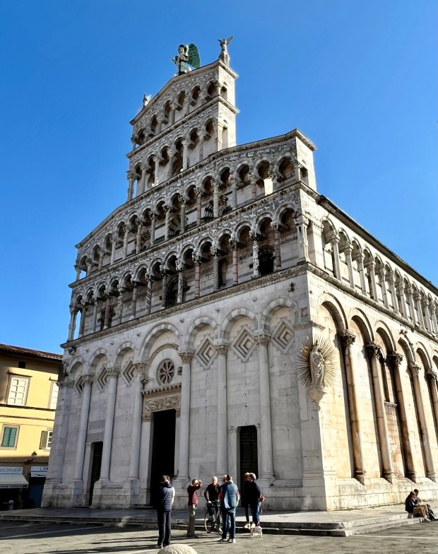 A marble-clad church under a bright blue sky