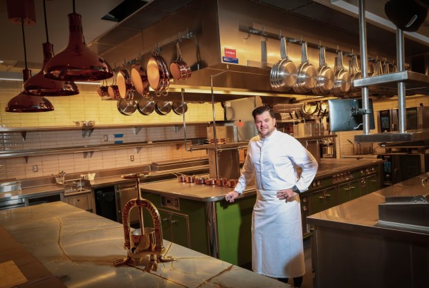 Travis Swikard, a Michelin recognized chef, stands by his Athanor stove from France in the kitchen of his new restaurant Fleurette on Thursday, Nov. 7 in the UTC area of San Diego. (Sandy Huffaker for The San Diego Union-Tribune)