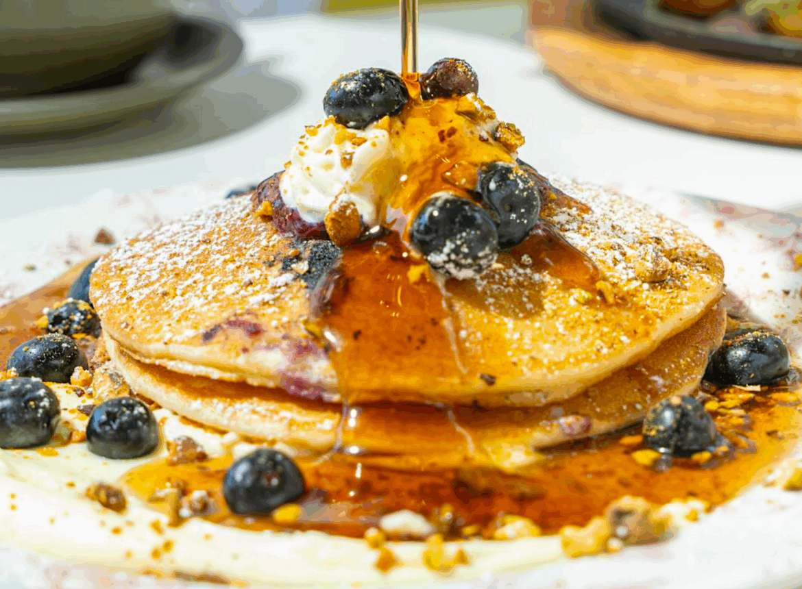 Trendy South Florida Café to Open First Weston Location pancakes dripping in maple syrup