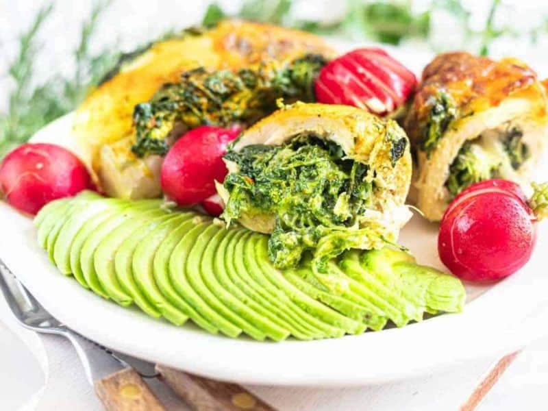 Spinach stuffed chicken breasts cut in half.