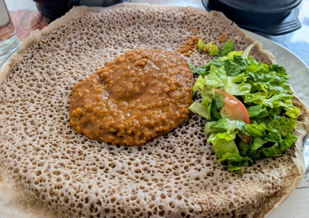 Yemisir wot key, a mixture of split red lentils with onion, garlic, ginger and turmeric, served over injera at Lucy Ethiopian Restaurant, at 7401 E. Colfax Ave., Denver. (Miguel Otarola/The Denver Post)