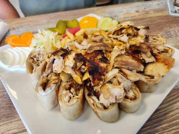 Chicken shawarma, Arabi-style, in small bites: skin and lamb fat, crisp pickle and killer garlic paste. (Amy Drew Thompson/Orlando Sentinel)