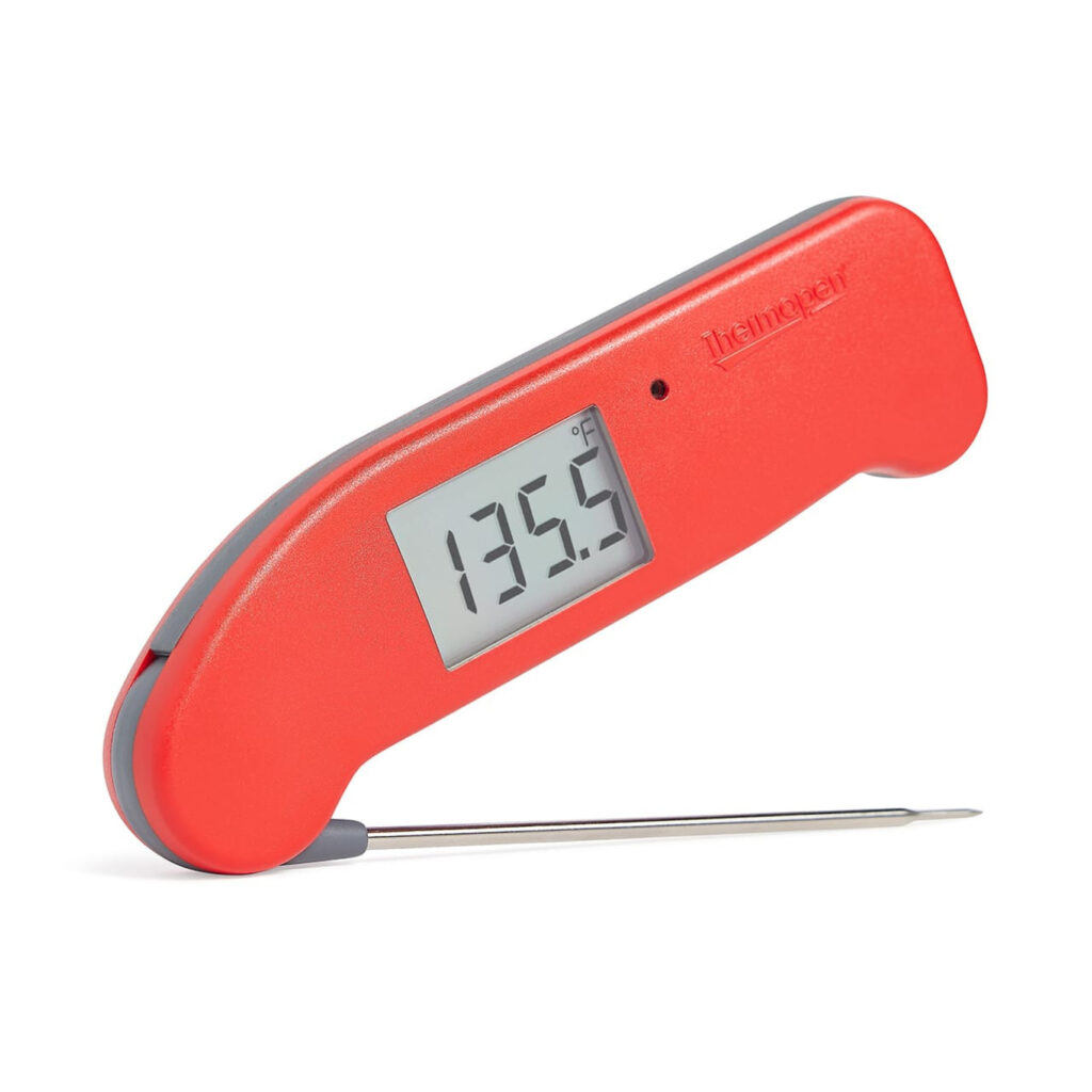 A red kitchen thermometer with 135.5 degrees on the digital display.