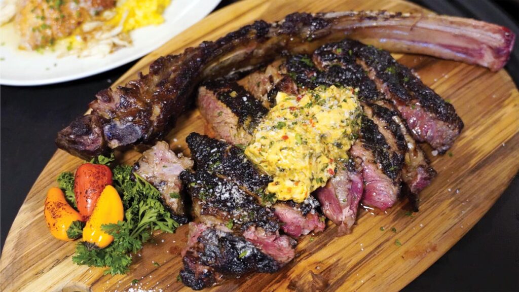 Tomahawk steak topped with chili butter. Photo by Angelina Mendez