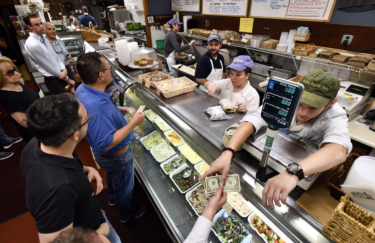 Staff assemble sandwiches during the lunch rush at the deli counter of the Concord Cheese Shop.