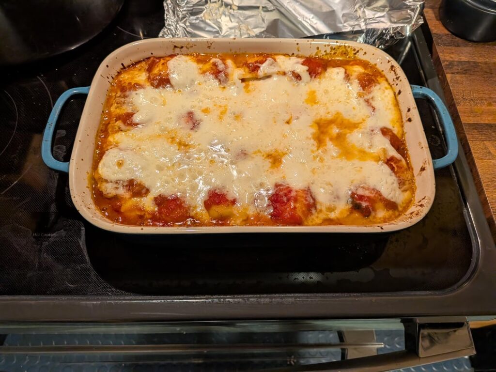 "Lazy" lasagna with homemade sauce, bechamel with reggianno, ravioli and fontina cheese
