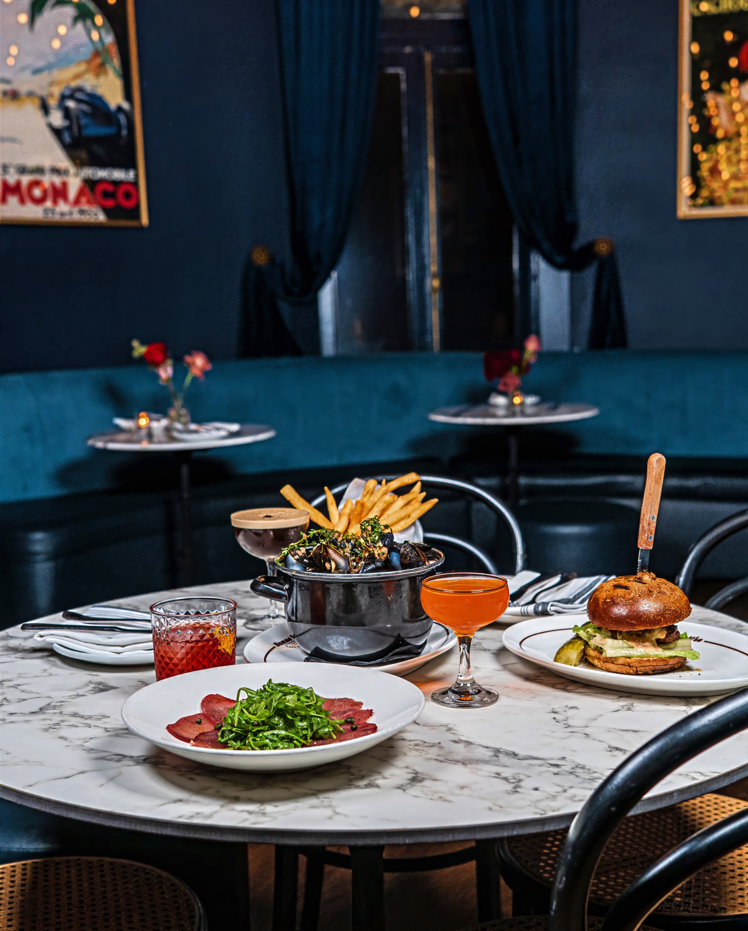 Bonne Vie’s chic upstairs dining room is framed with vintage French prints.