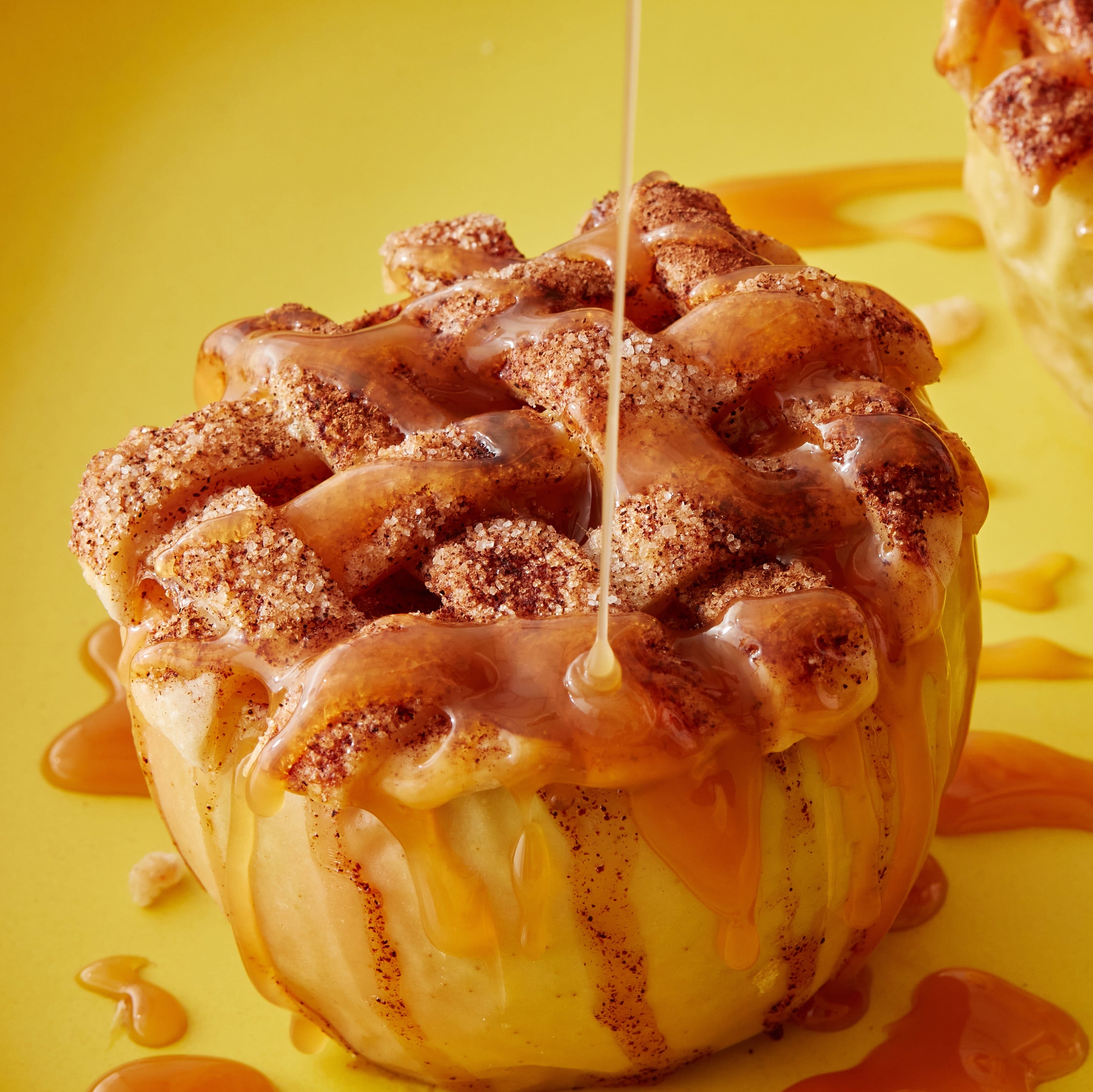 baked apples in the air fryer topped with a lattice crust and caramel