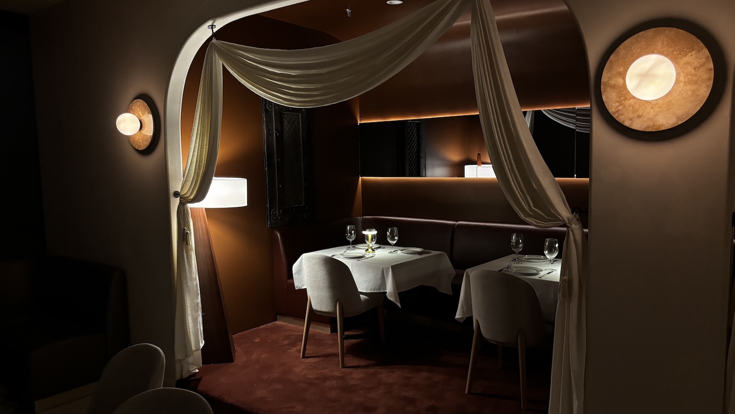 Dimly lit tables and accent lights in Babel's new dining area.