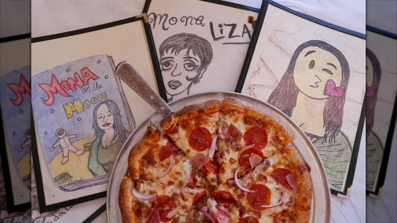 Mona Lisa illustrations on yellow brick wall