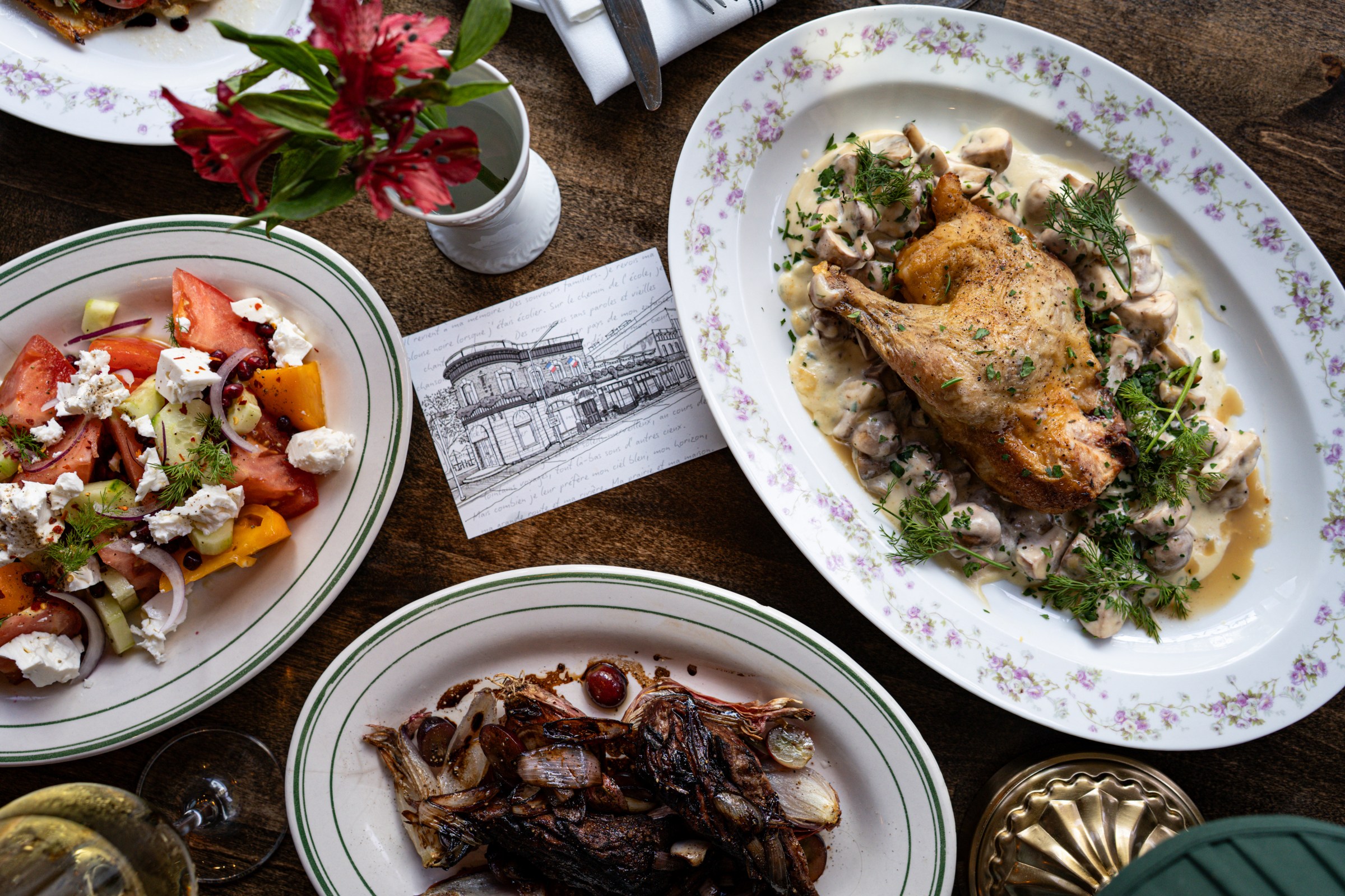 A sketch of the historic flatiron building Bonne Vie occupies appears on the menu and postcards.