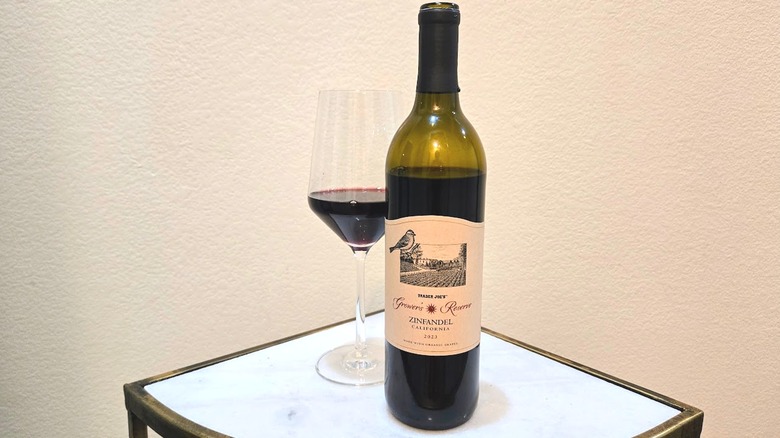 Trader Joe's Grower's Reserve Organic Zinfandel and glass on a coffee table