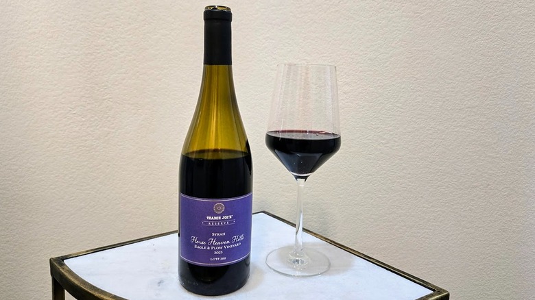 Trader Joe's Reserve Horse Heaven Hills Syrah bottle with a glass filled with wine