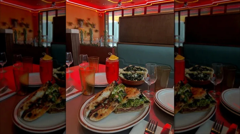 Italian sandwiches on booth table with red lighting