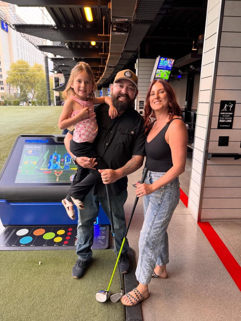 California-based food influencer Michael Duarte with his daughter and wife at a Topgolf facility.