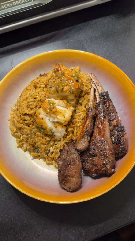 Coconut Chilean sea bass with lamb chops rice and salad.