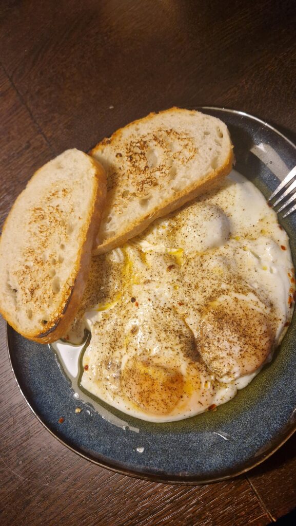 Fried eggs, Greek yogurt, butter with chili flakes and croutons