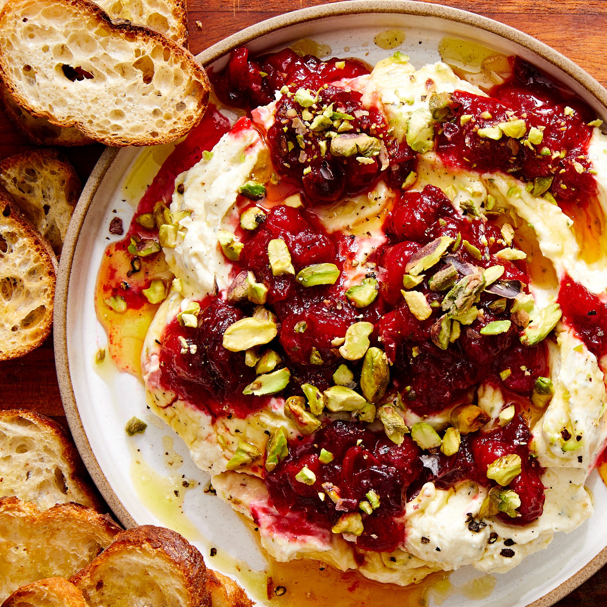 whipped garlic and herb feta, topped with fresh cranberry sauce, pistachios, and honey