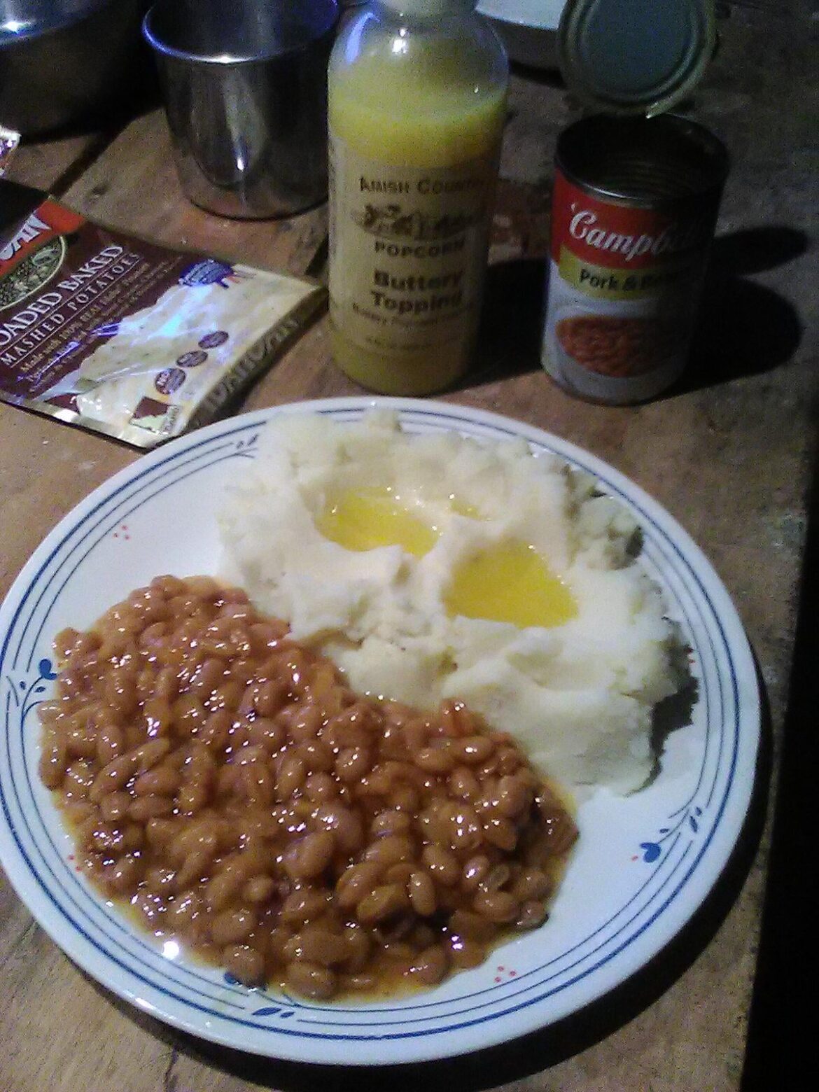 Todays ration. Half a pack of powdered mash potatoes, with soy based butter flavored popcorn topping, and a can of beans i got from someone who was throwing them out.