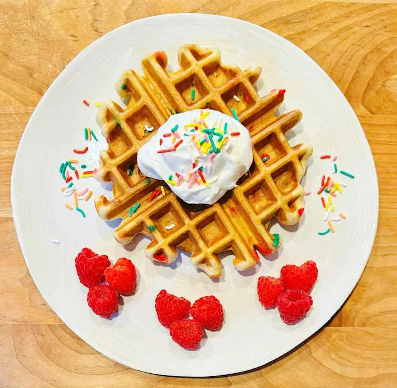 A waffle topped with whipped cream