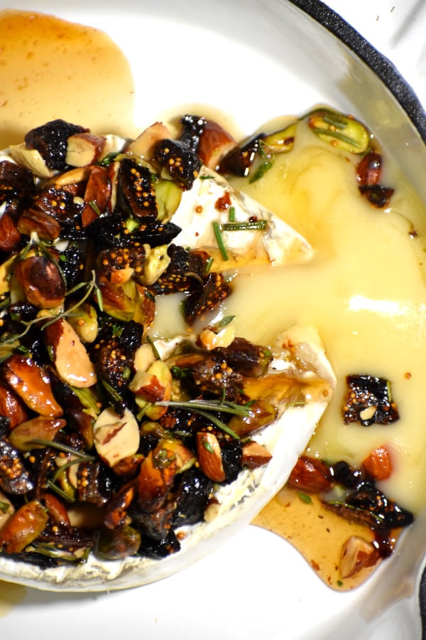 baked brie topped with nuts and honey