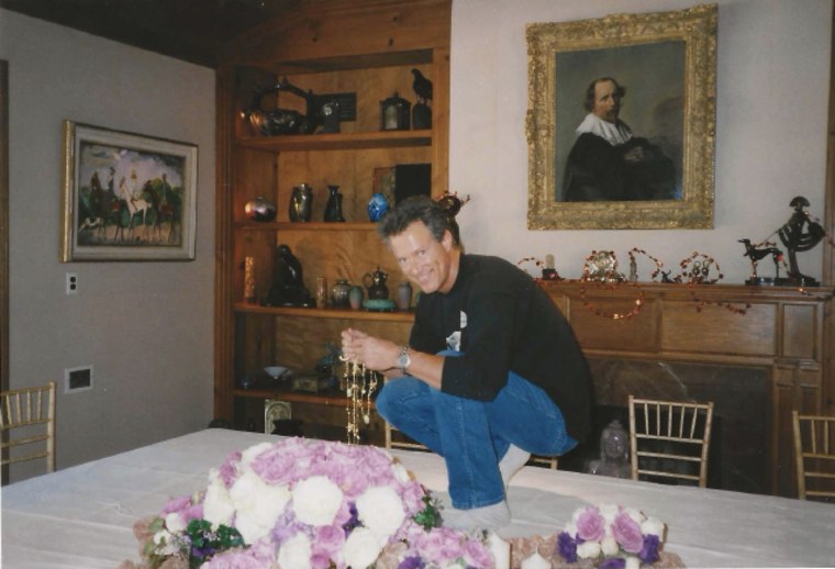 Neil Zevnik decorates a table for a Thanksgiving dinner at Elizabeth Taylor's home.