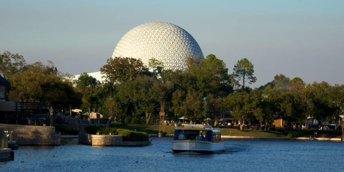 A FriendShip ferry boat on the World Showcase Lagoon at EPCOT. Spaceship Earth is in the background at Disney World.