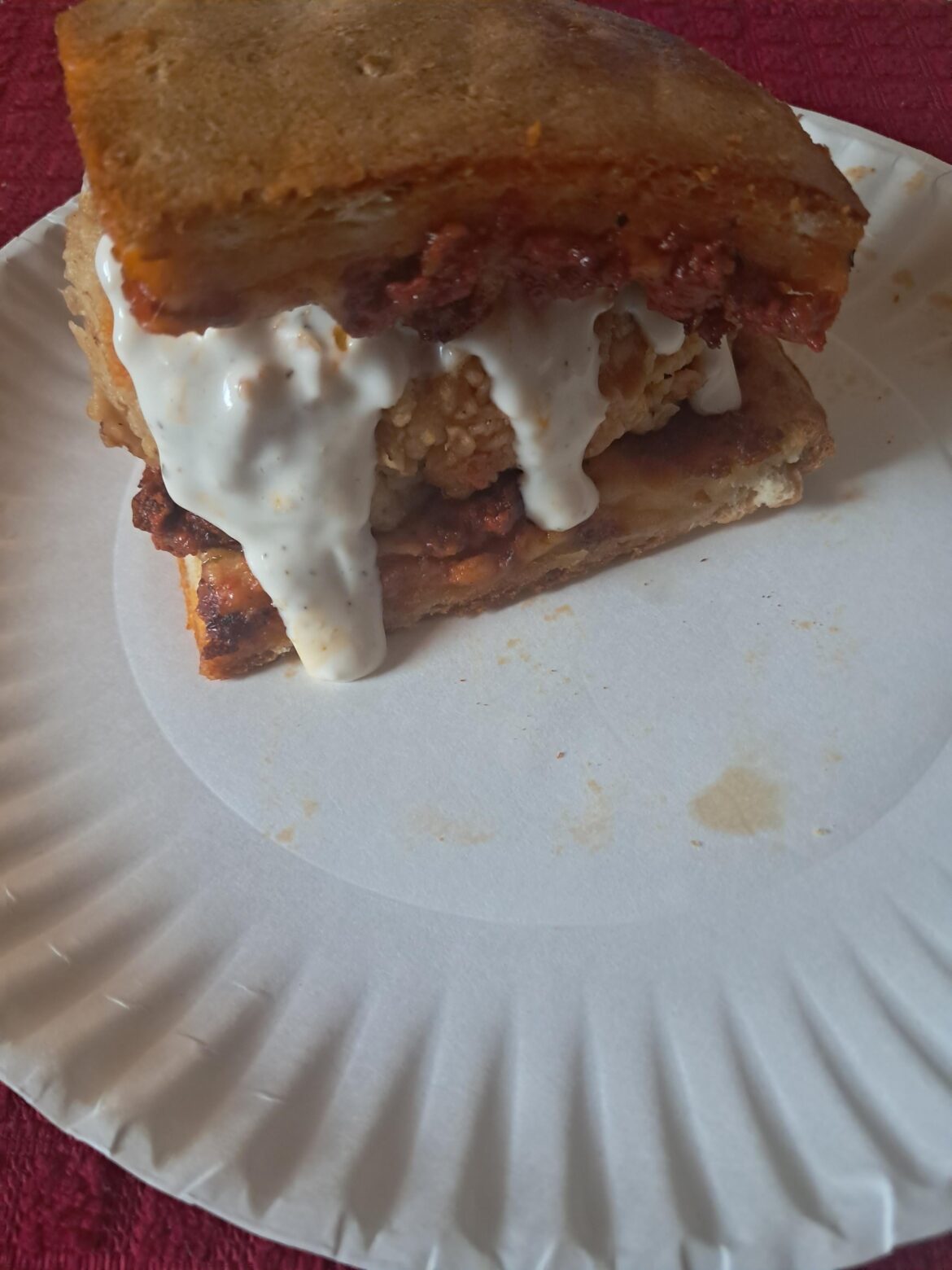 Chicken tender sandwich with leftover pizza as bread and parmesan ranch.