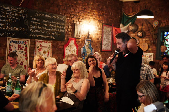 Giovanni Mico serenades patrons in the dining room.