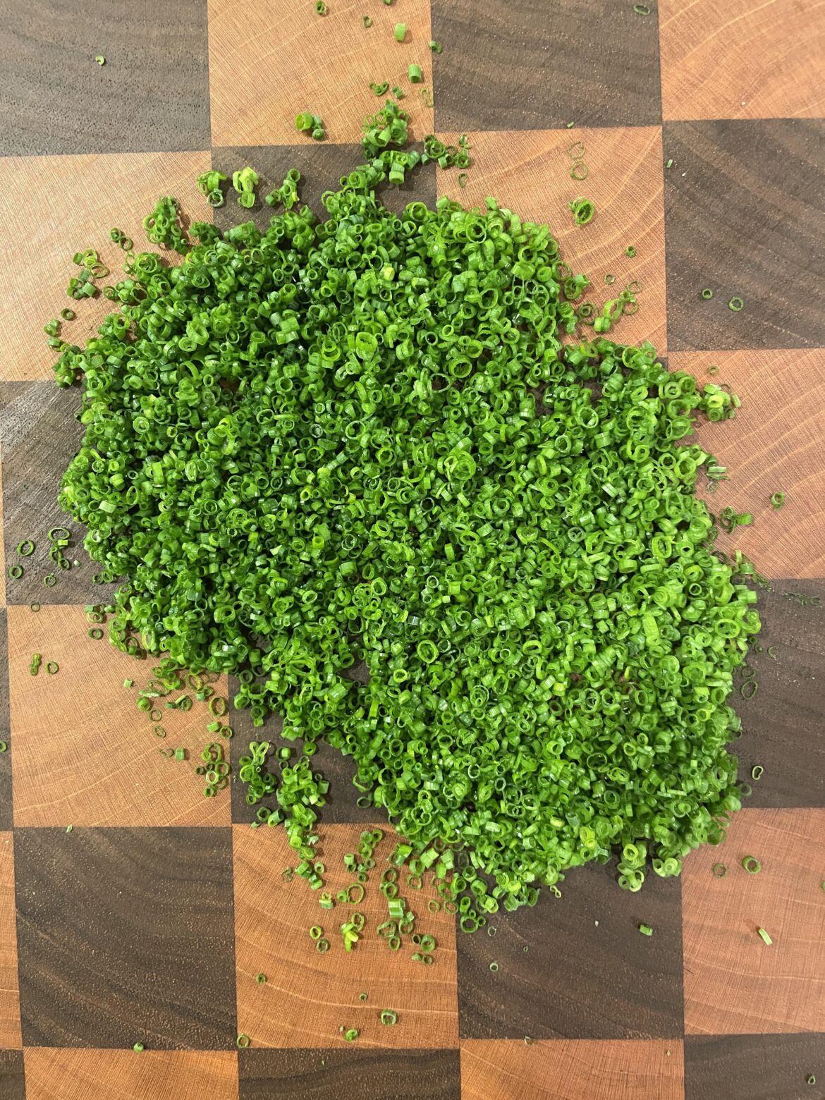 Cutting a couple of chives almost every day until this reddit says they're perfect. Day 48