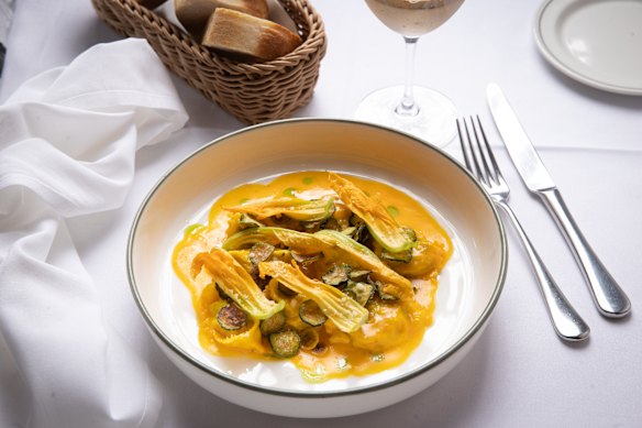 Plin (small ravioli) stuffed with ricotta, zucchini and leek, with saffron and zucchini flowers.