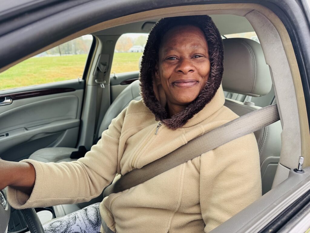 woman smiling from car window