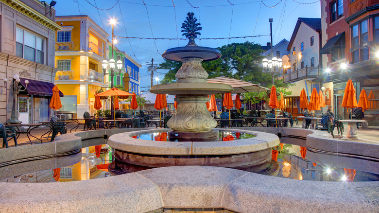 A fountain surrounded by tables with umbrellas in Providence's Federal Hill neighborhood