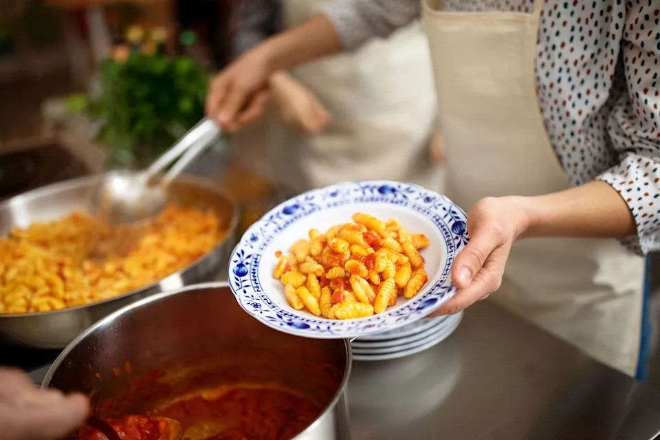 Getty Person serving up pasta (stock image)