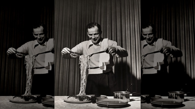 Black-and-white photo of Frank Sinatra serving spaghetti