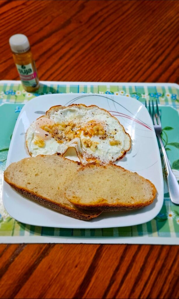 Runny garlicy eggs with buttered toasted sourdough bread.