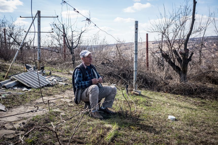 A winemaker sits amid the remains of his vineyard in a Donetsk village after it was destroyed by Russian forces in 2024.