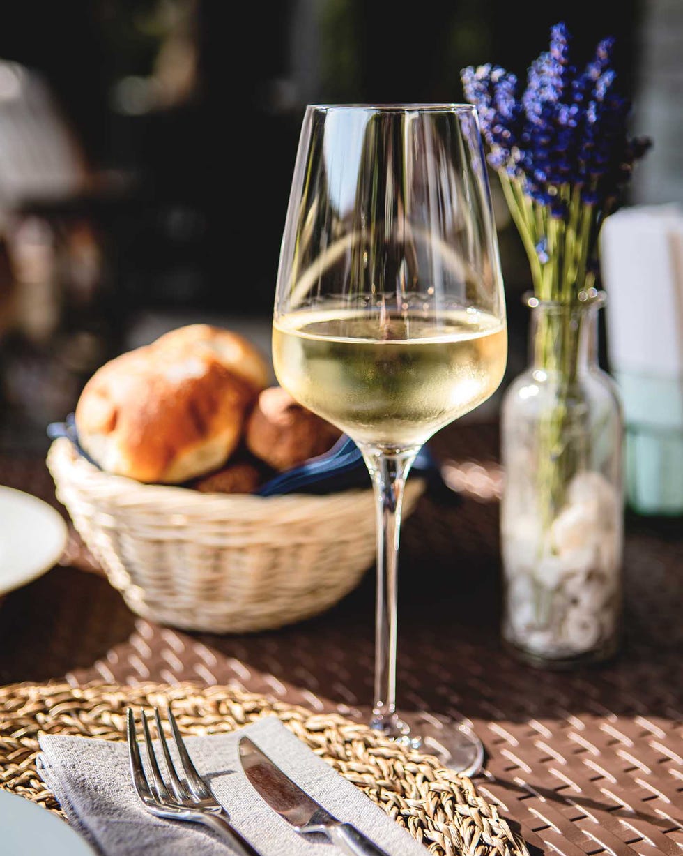 glass of white wine at a place setting