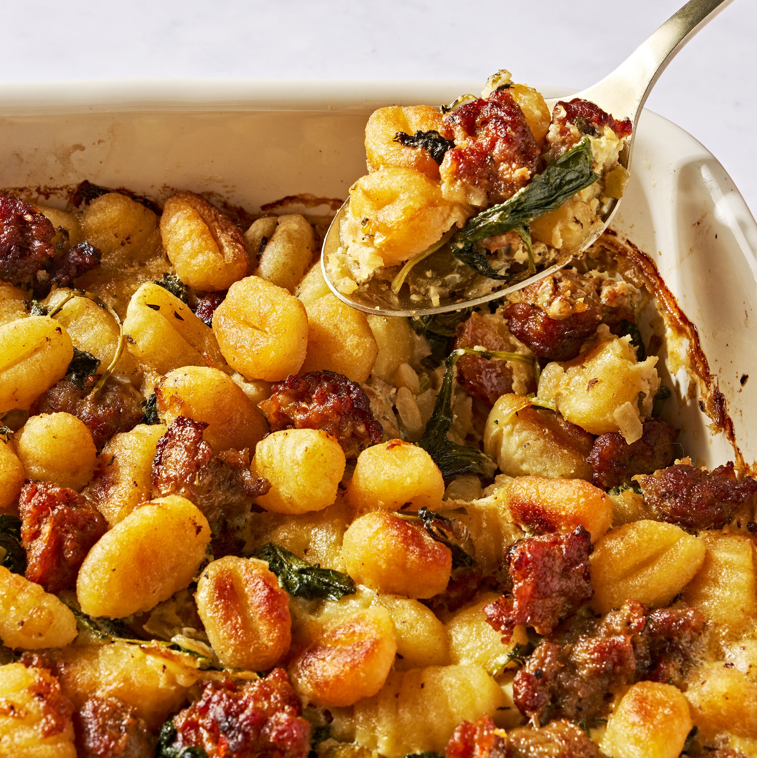 gnocchi and sausage stuffing in a white baking dish