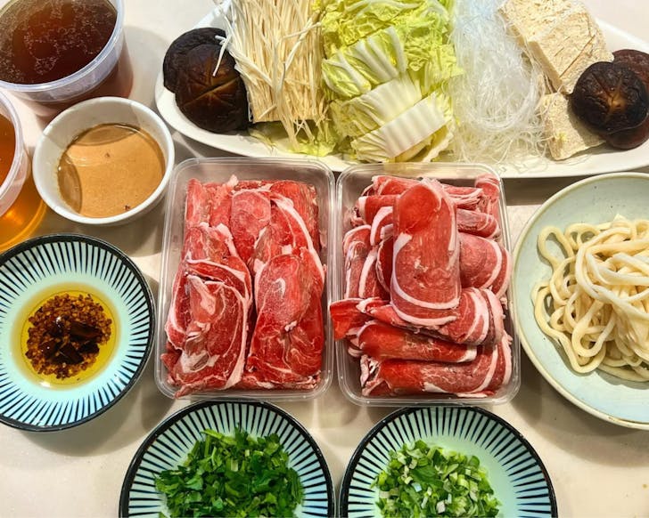 tbc by grape garden is a potts point restaurant, pictured is a flatlay of hot-pot offerings including meat and vegetables before they have been cooked