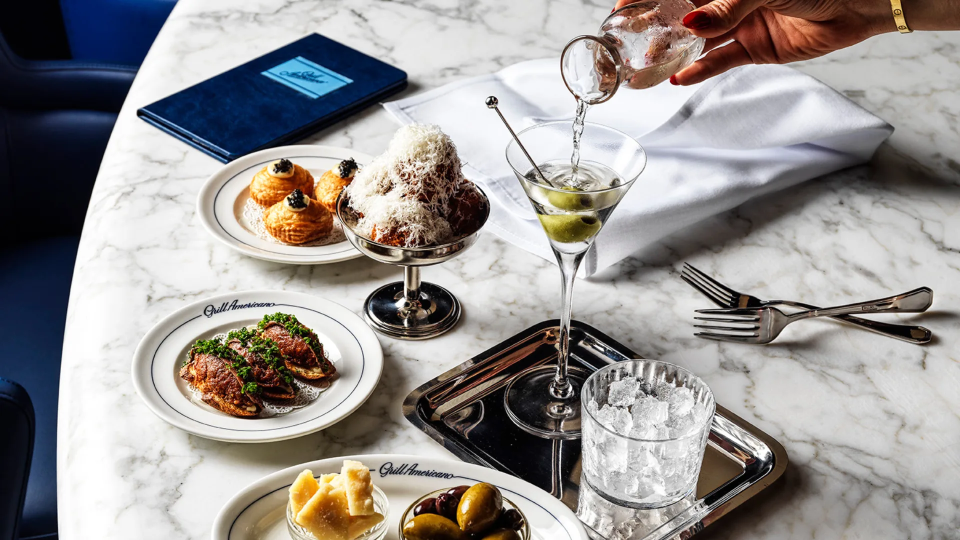 A selection of snacks and a martini at Grill Americano Sydney