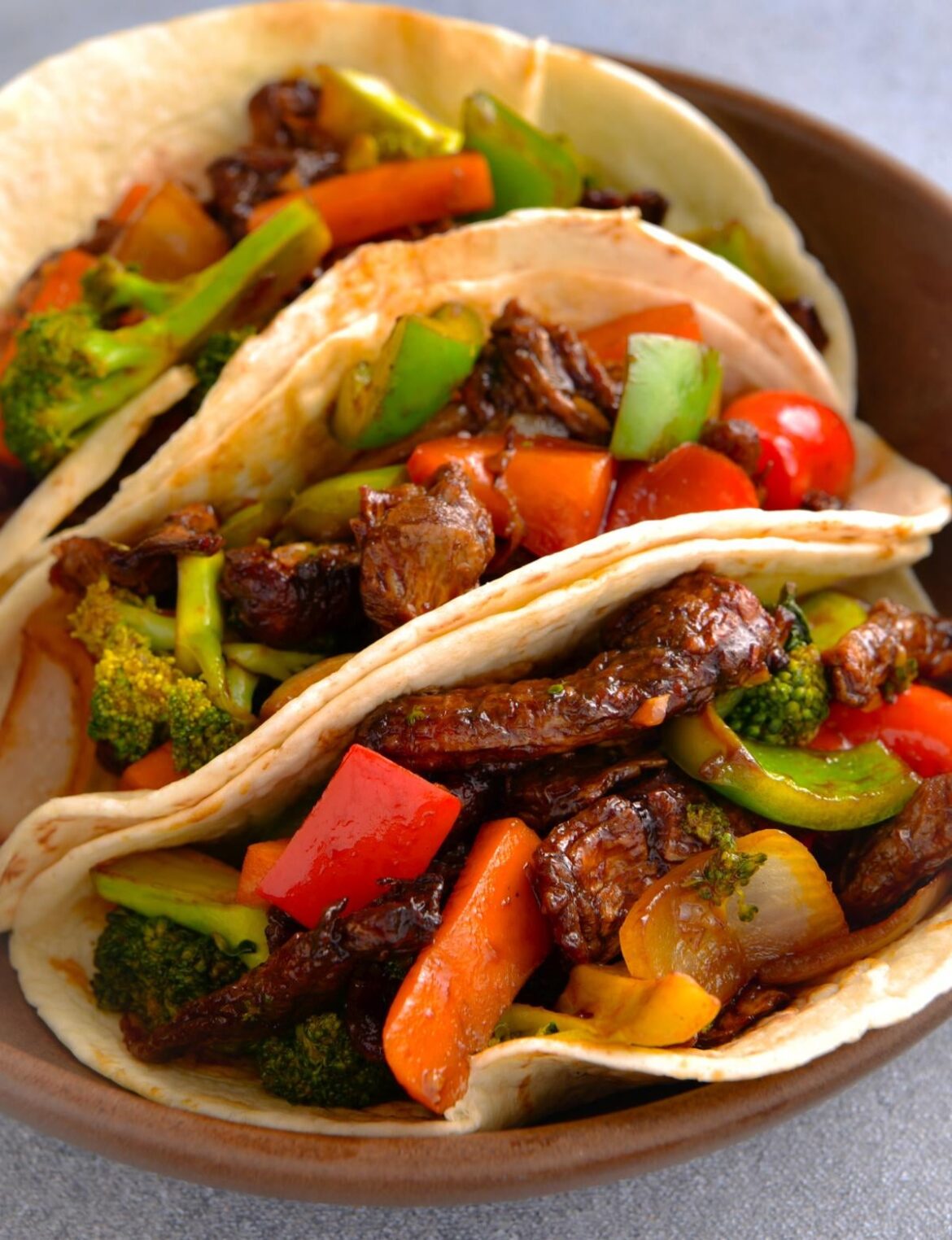 Vegan soy curls cooked in air fryer then tossed with veggies