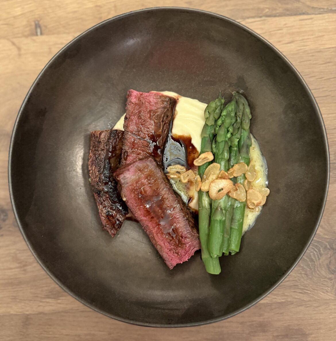steak, demi glacé, parsnip purée, asparagus, fried garlic, buerre blanc