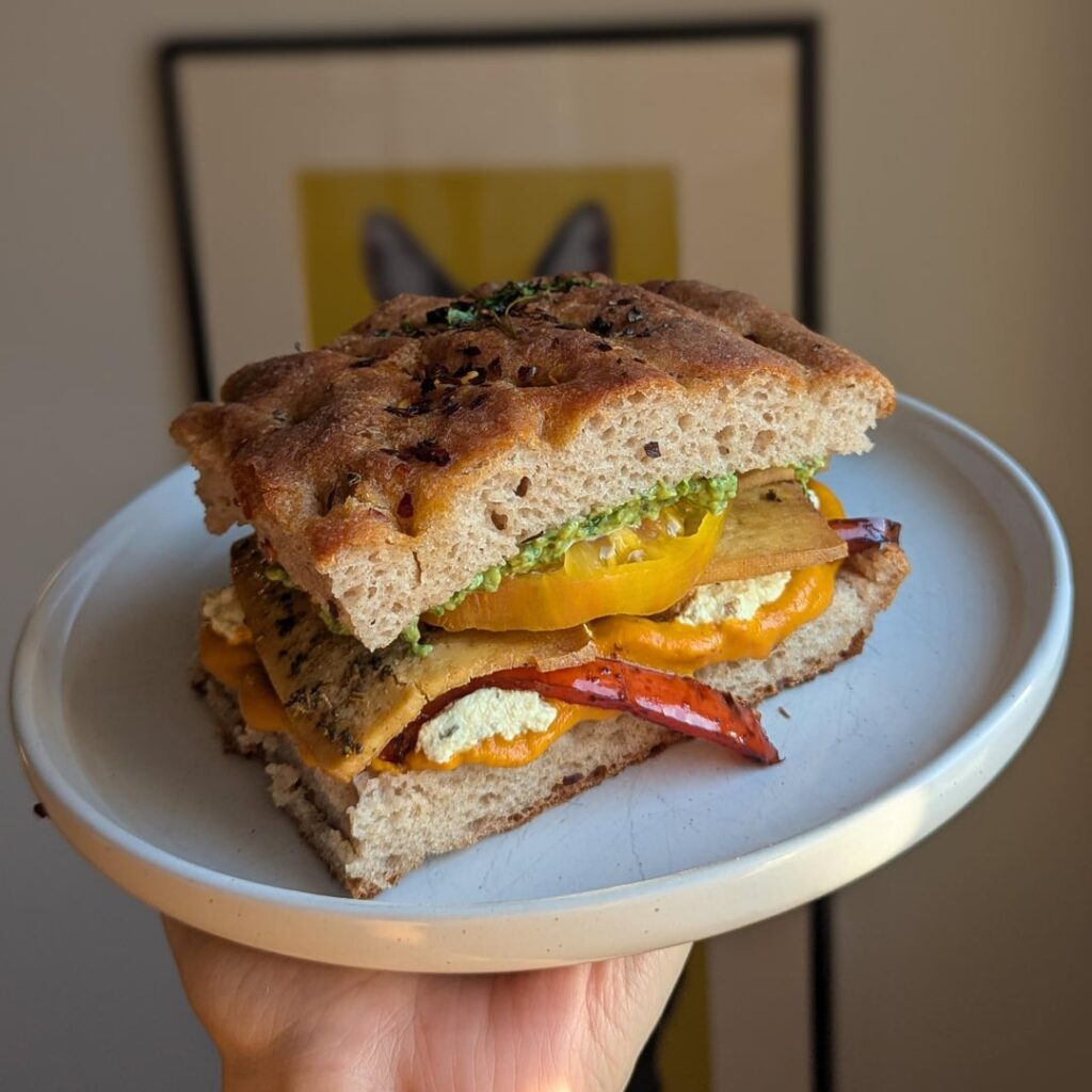 pesto and smoky red pepper sauced TuRkEy sandwich with herbed ricotta and balsamic vegetables on freshly baked gluten free focaccia.