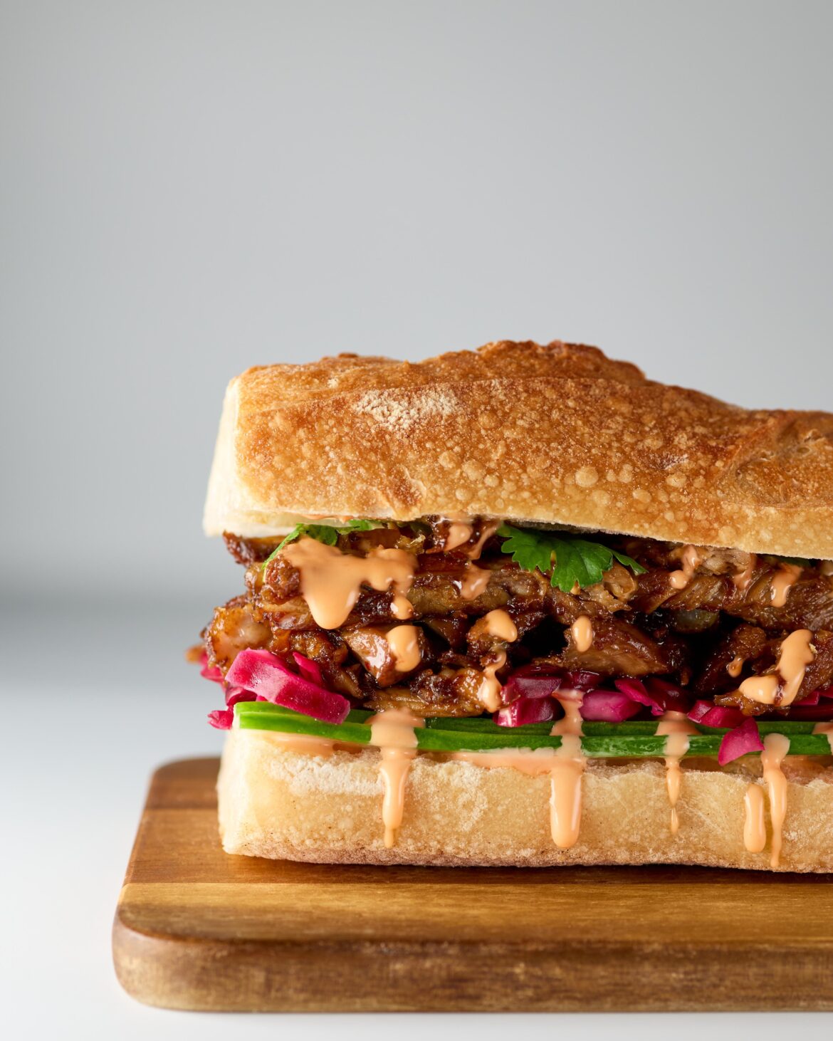 Ribs glazed with miso, ginger, sambal oelek, soy, garlic, and maple syrup. Yuzu-pickled red cabbage, toasted panko, cilantro, cucumber, and sriracha mayo.