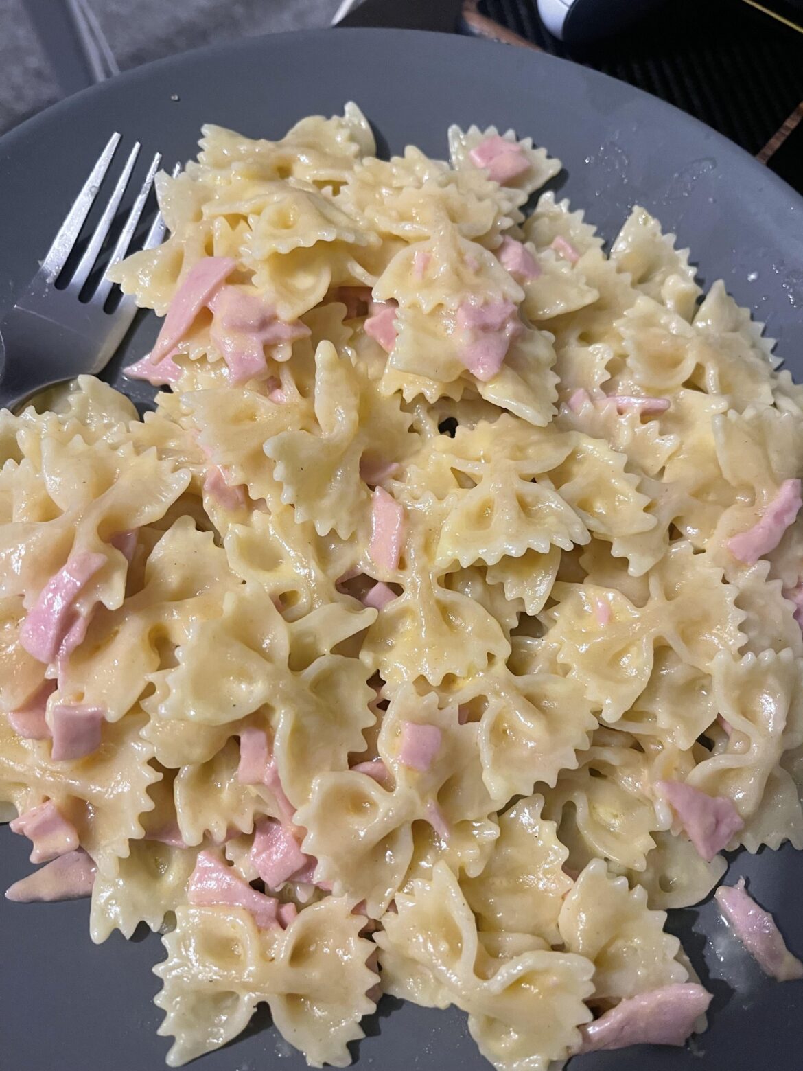 Pasta, butter, cheese and ham slices.